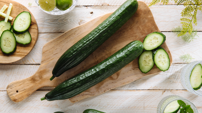 English cucumbers on cutting board