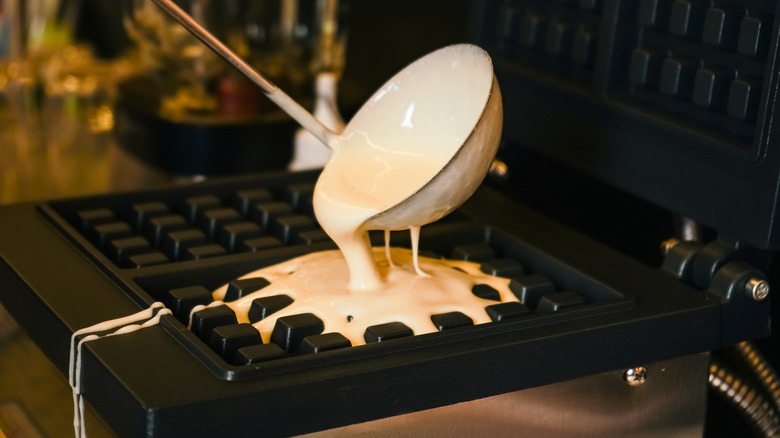 pouring batter onto waffle maker