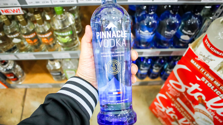 person holding bottle of Pinnacle vodka 