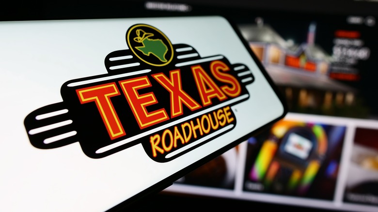 Cell phone with Texas Roadhouse logo