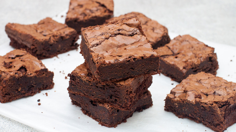 Brownie squares on a piece of parchment paper