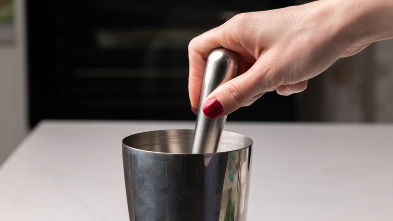 muddling lychee Thai basil martini