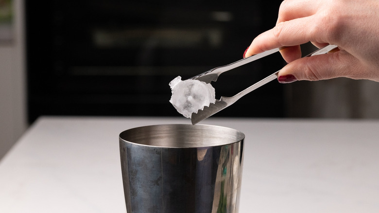 adding ice to cocktail shaker