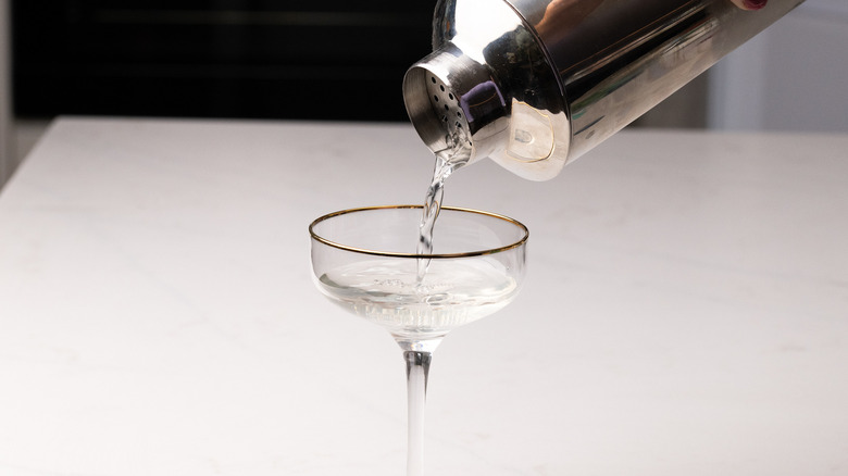 pouring martini into glass