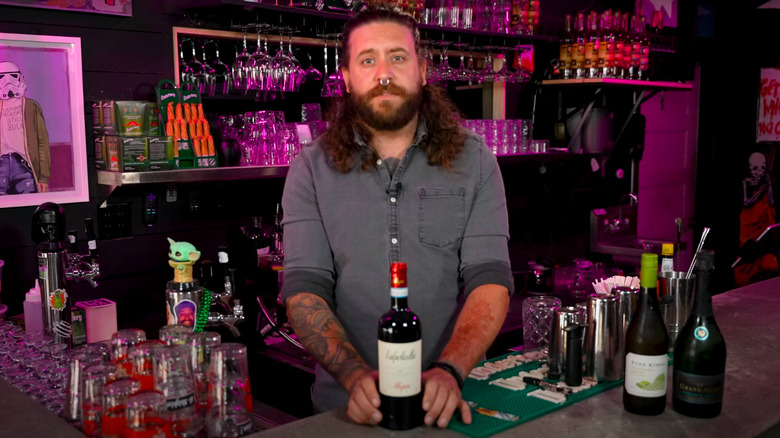 Kamaron Lockwood standing behind bar