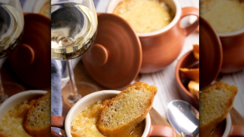 Glass white wine with French onion soup