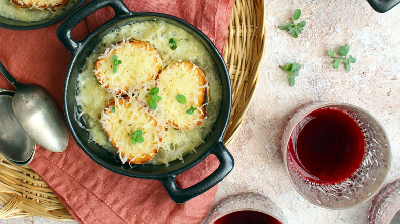 French onion soup with tumbler of red wine