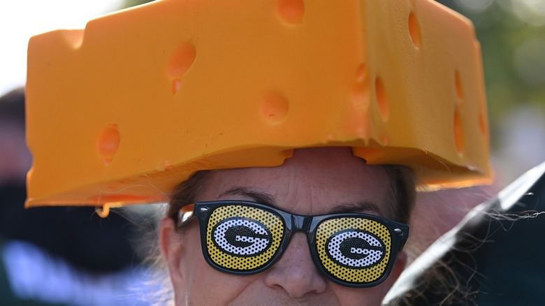 Person in cheese hat and Packers sunglasses