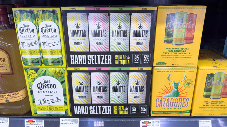 Canned tequila drinks on the shelf at the liquor store, varying brands