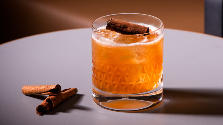 Whiskey in a glass with cinnamon garnish