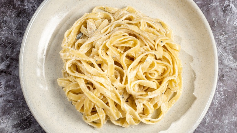 Overview of long pasta in a creamy sauce on a plate