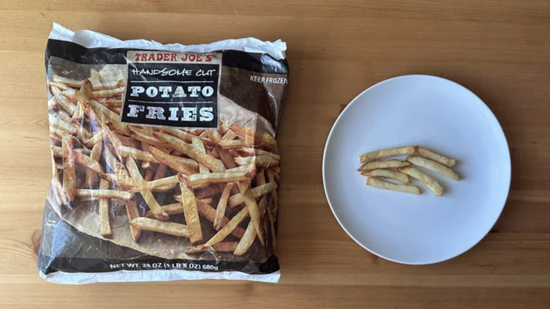 a bag of Trader Joes Handsome cut potato fries and a plate with some fries on it