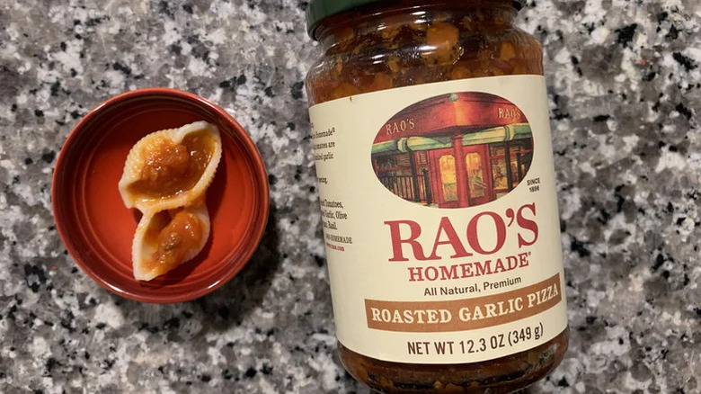 Rao's homemade garlic pizza sauce in a jar and on pasta shells