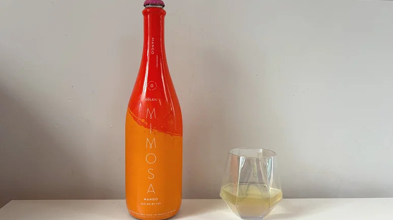 A bottle of Soleil Mimosa Mango and a wine glass