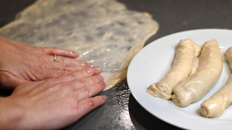 woman forming jachnun dough 
