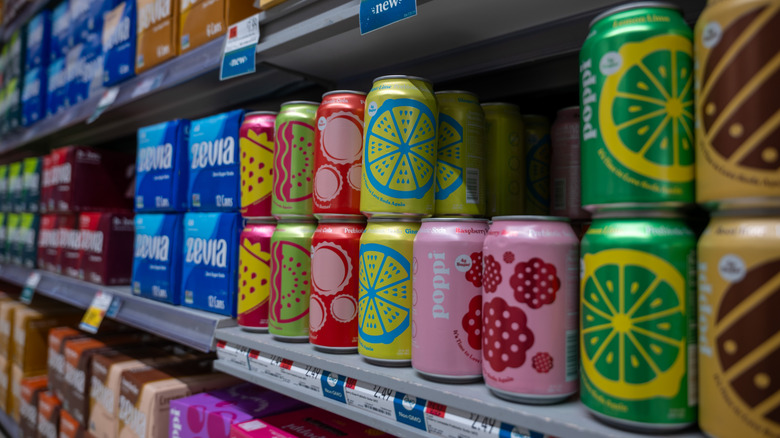 cans of Poppi soda on shelves