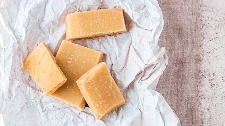 Parmesan cheese rinds on crinkled white paper