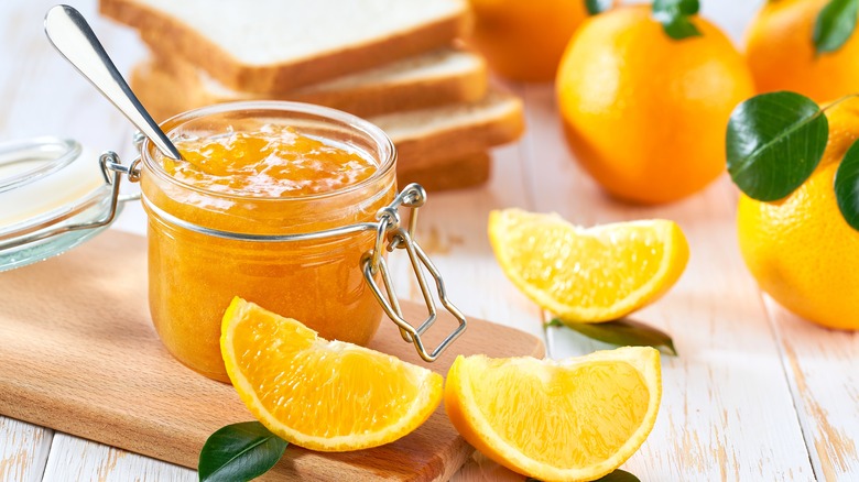 jar of marmalade and sliced oranges