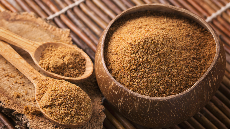 Palm sugar in a bowl with two spoons