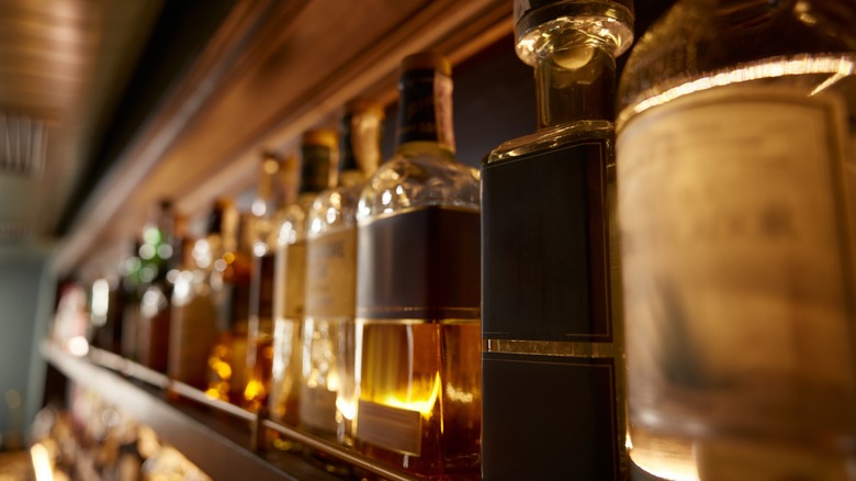 whiskey bottles on wood table