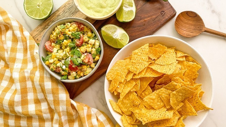 Elote-style dip with bowl of tortilla chips