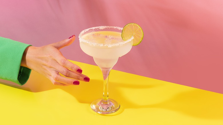 Hand grabbing margarita 