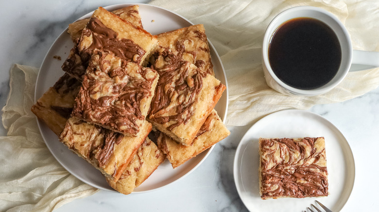 stacked banana Nutella bars on plate with coffee