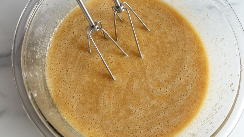 beating eggs and banana into butter and sugar mixture