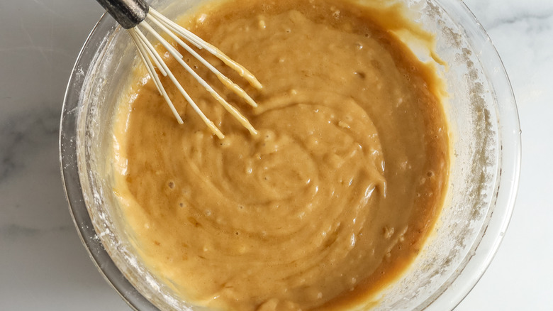 whisking banana bar batter in bowl
