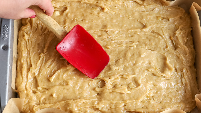 spreading banana bar batter into pan