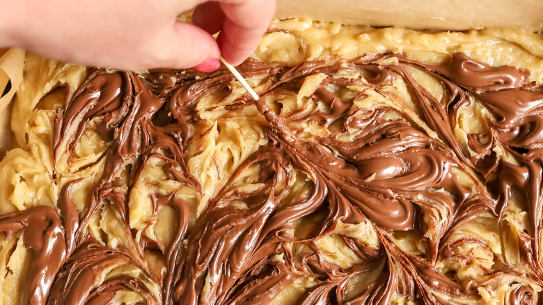 swirling Nutella into batter with toothpick