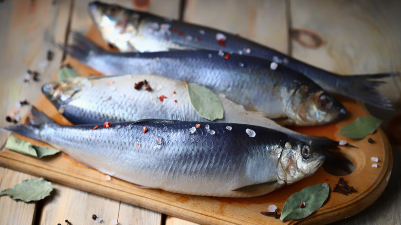 salted herring on wooden platter