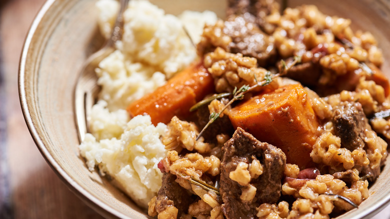Beef stew and barley in plate