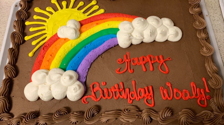 Costco chocolate birthday cake with rainbow and red writing