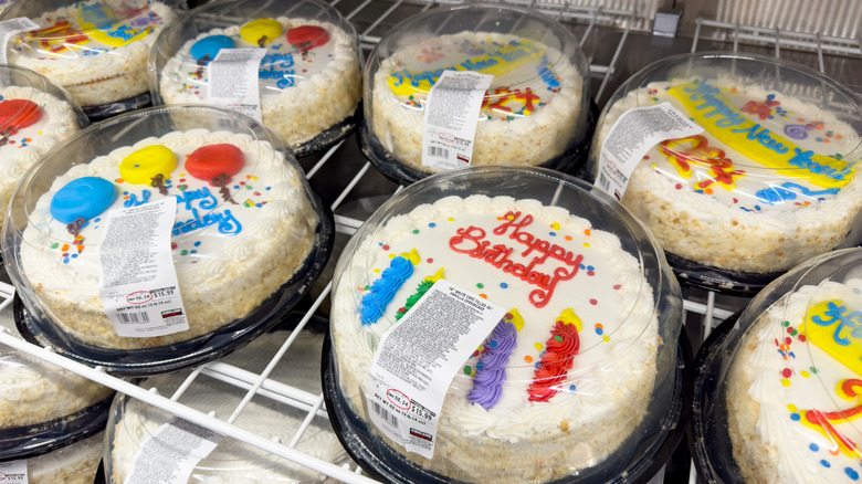 Costco round white decorated birthday cakes in bakery case