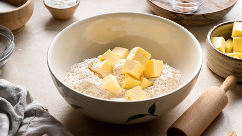 butter and flour in bowl to make biscuits