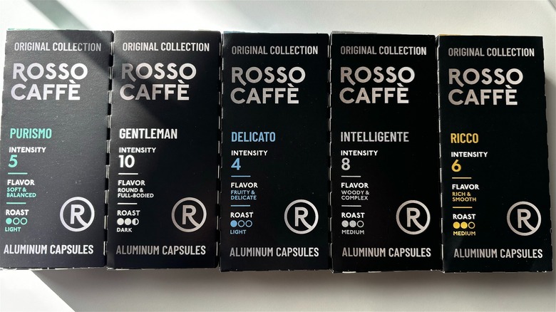 five boxes of rosso caffe nespresso pods next to each other on table