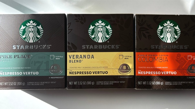 three boxes of starbucks vertuo nespresso capsules next to each other on table