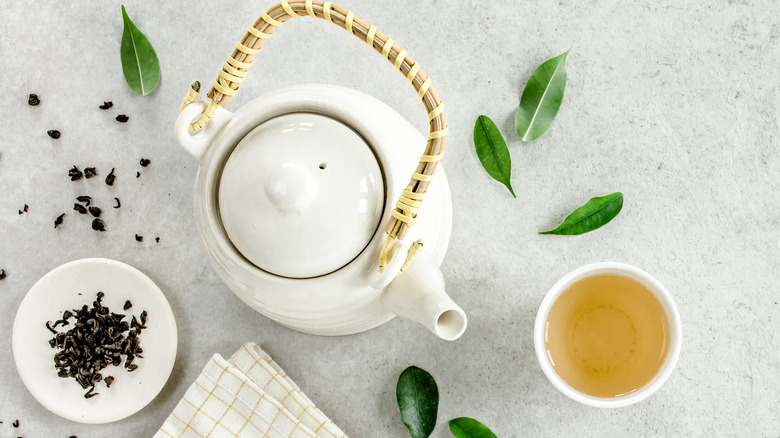 tea kettle, mug, and tea leaves