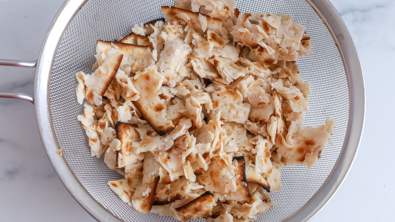 Wet matzo in a strainer