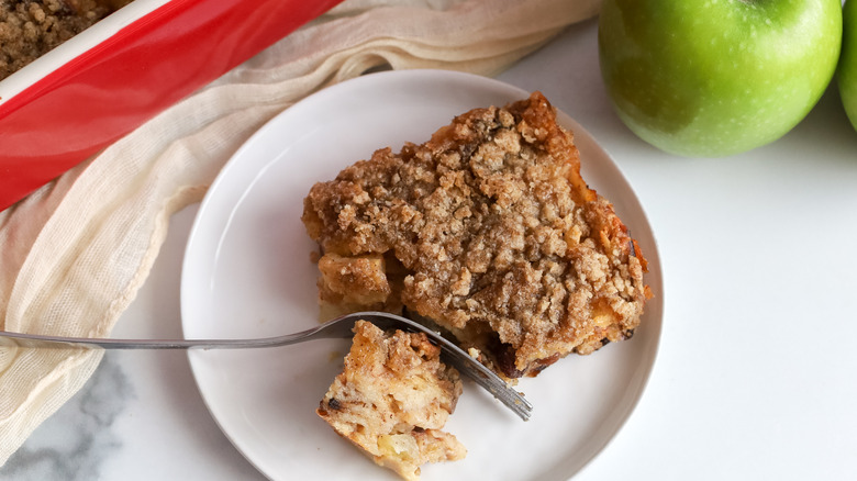 Sice of apple matzo kugel being cut into with a fork