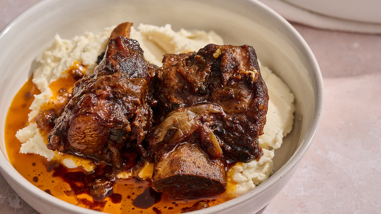 braised short ribs on potatoes in bowl