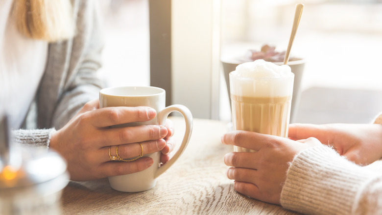 Two women holding coffees