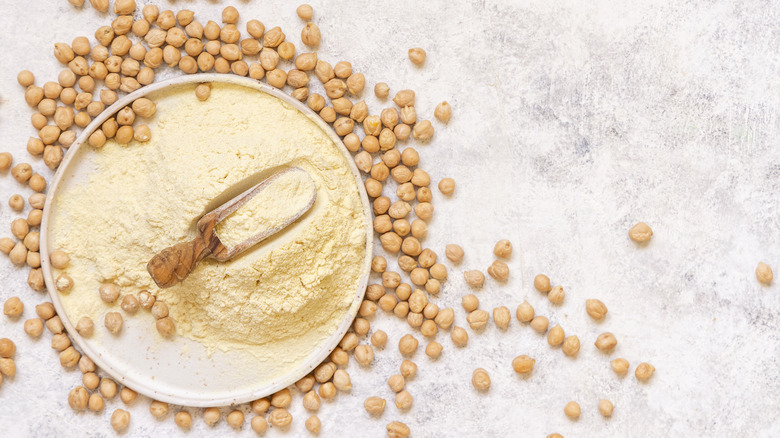 Chickpea flour surrounded by dried chickpeas