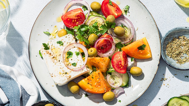 plate of salad with green olives