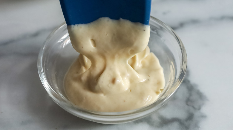 truffle aioli being spooned into a bowl