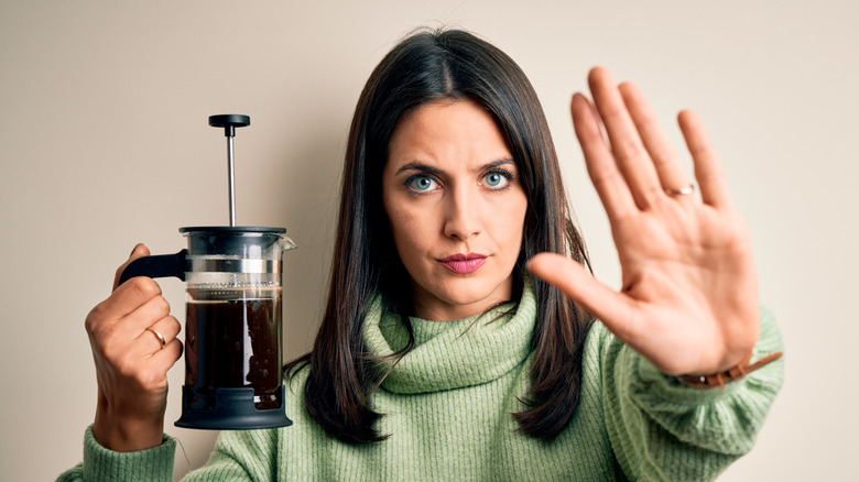 woman french press hand stop