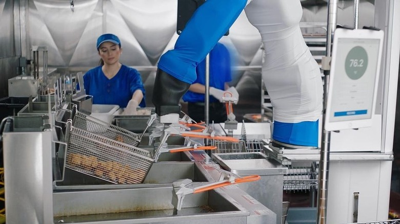 A Flippy robot manning a fryer in a restaurant kitchen