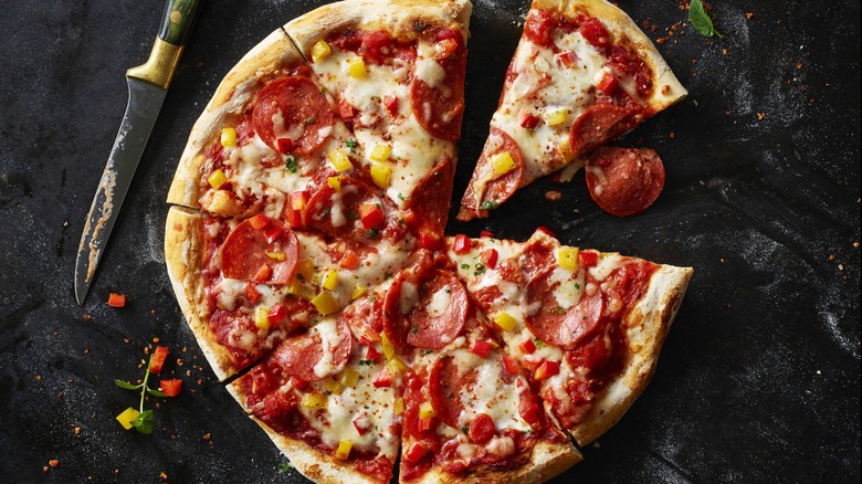 Overview of a sliced pizza with one piece missing