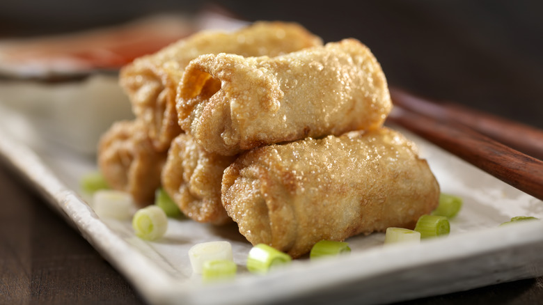 Miniature egg rolls on a plate.